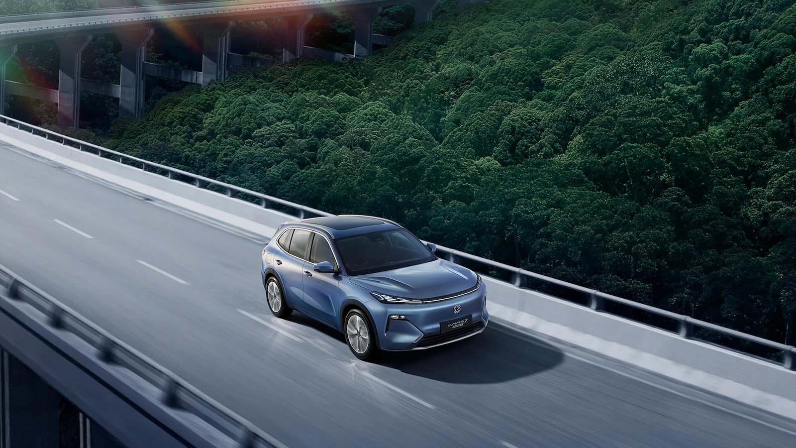 e.MAS 7 PHEV driving on an elevated highway through the forest